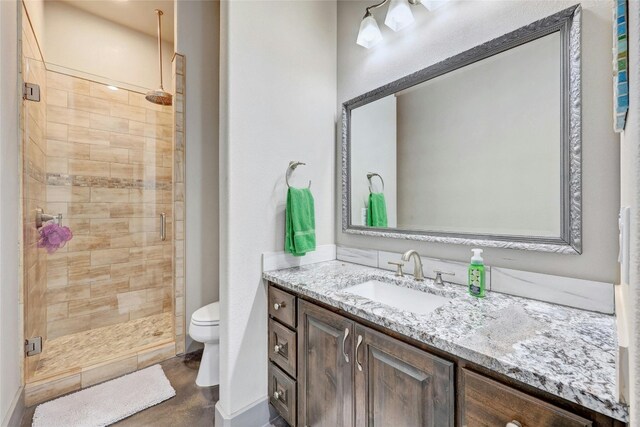 bathroom with vanity, toilet, and walk in shower