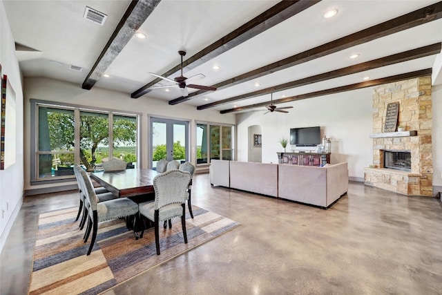 dining area with beamed ceiling, a fireplace, french doors, and ceiling fan