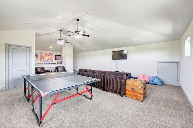 game room featuring vaulted ceiling and light colored carpet