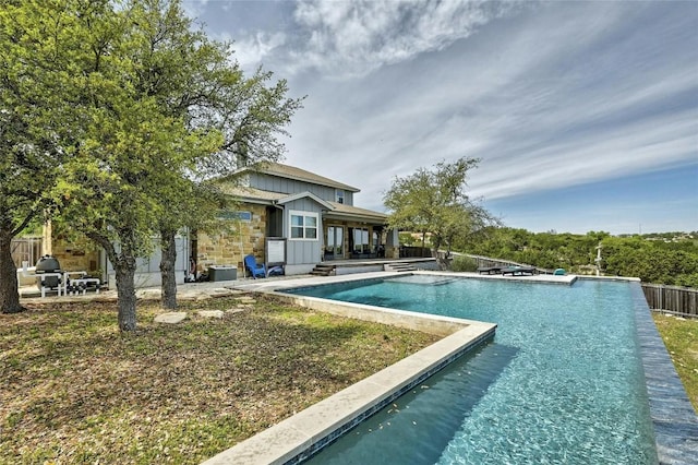 view of swimming pool featuring a patio area