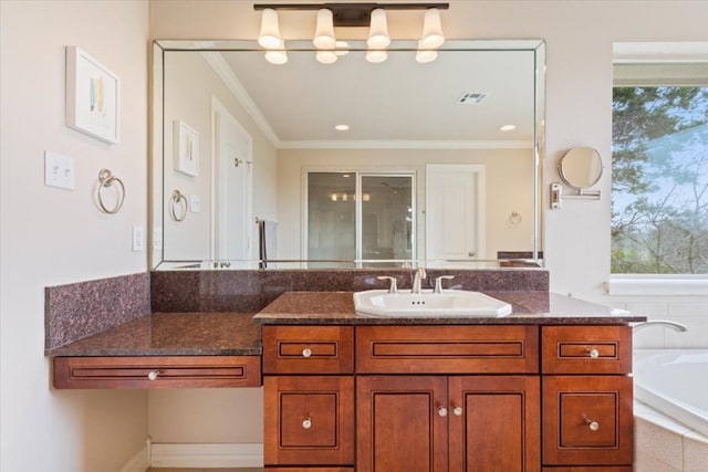 bathroom featuring vanity, ornamental molding, and tiled bath