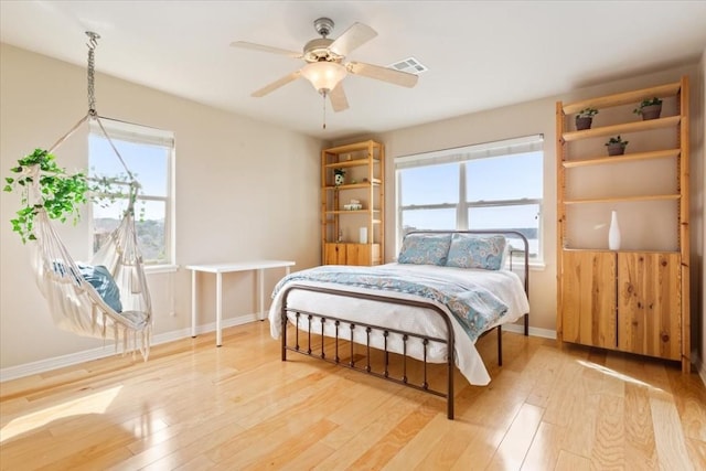 bedroom with ceiling fan and light hardwood / wood-style flooring