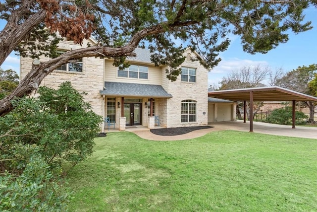 view of front of home featuring a carport, a garage, a front yard, and french doors