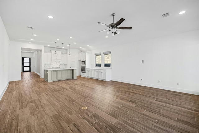 unfurnished living room with hardwood / wood-style floors and ceiling fan