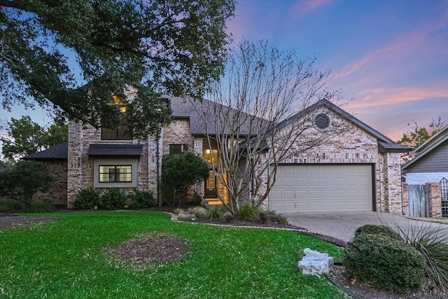 view of front of house featuring a garage and a lawn