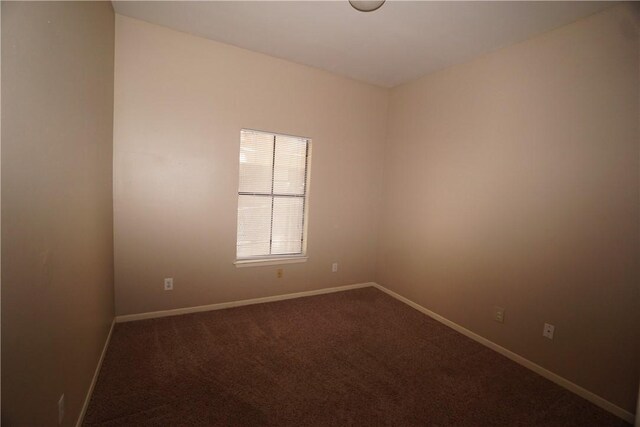 712 Graham Pl Unit 203, Austin, TX 78705 - empty room featuring dark colored carpet and baseboards