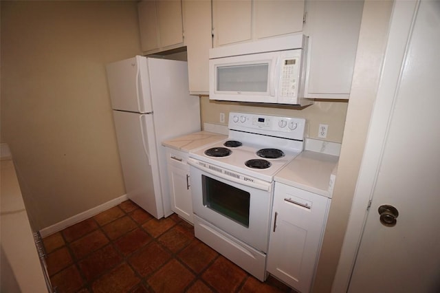 kitchen with white cabinetry and white appliances