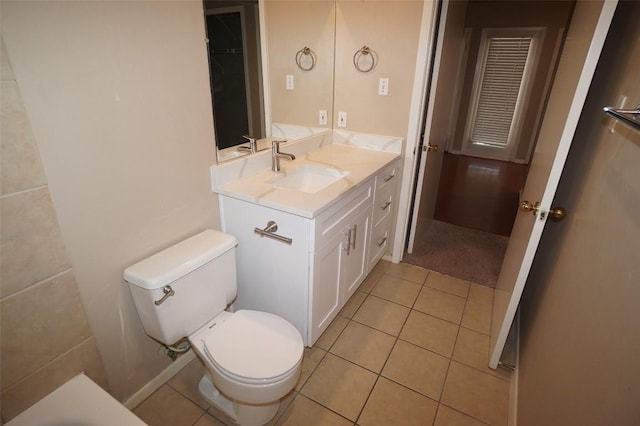 bathroom with vanity, a bathtub, tile patterned floors, and toilet