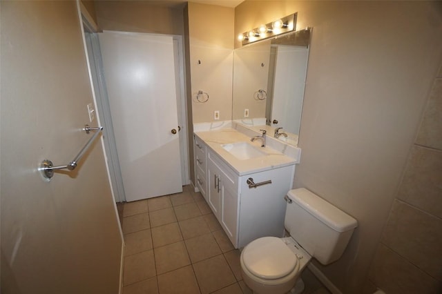 bathroom featuring vanity, tile patterned floors, and toilet