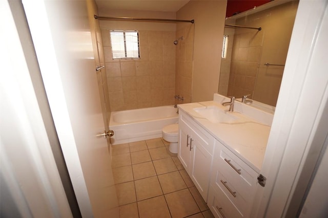 full bathroom featuring vanity, tiled shower / bath, tile patterned floors, and toilet