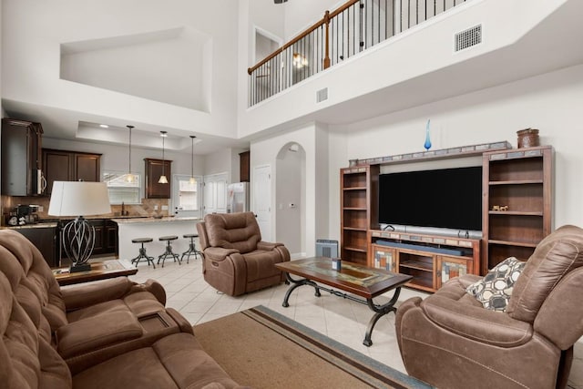 tiled living room with a towering ceiling