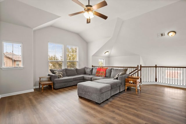 living room featuring a healthy amount of sunlight, dark hardwood / wood-style flooring, and vaulted ceiling