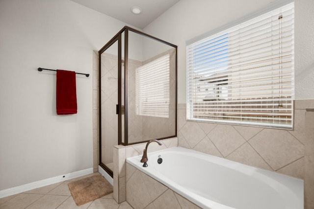 bathroom featuring tile patterned flooring and separate shower and tub