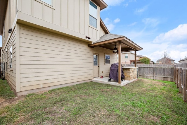 rear view of property featuring a lawn, a patio, and ceiling fan