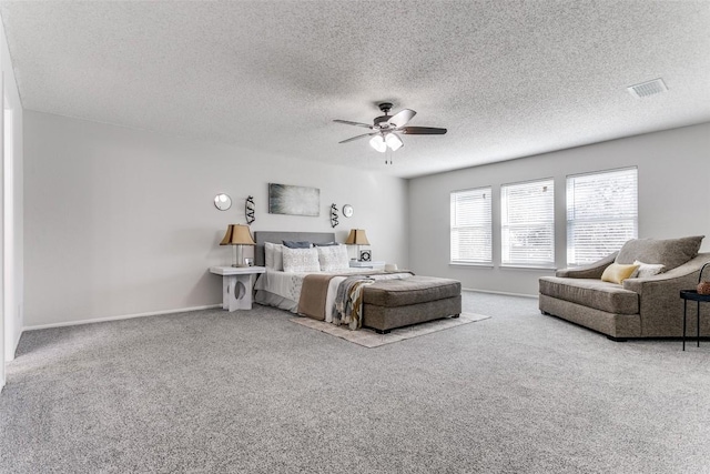 carpeted bedroom with a textured ceiling and ceiling fan