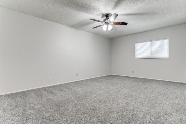 carpeted spare room with ceiling fan and a textured ceiling