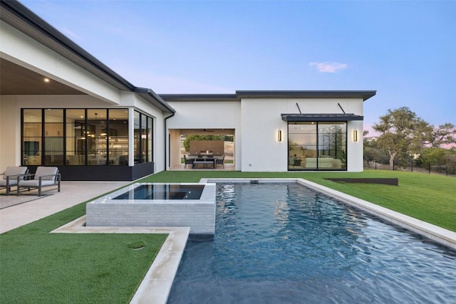 view of pool featuring a yard, a patio area, exterior kitchen, and an in ground hot tub