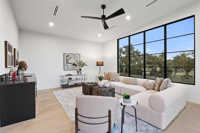 living room featuring ceiling fan and light wood-type flooring