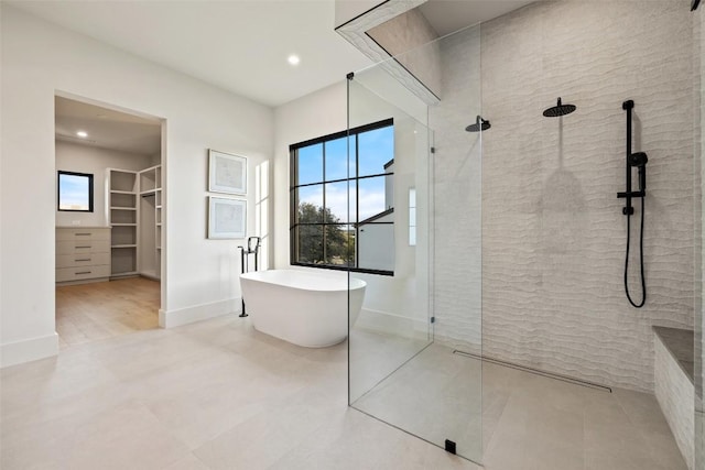 bathroom featuring independent shower and bath