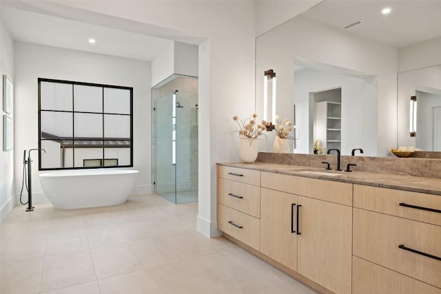 bathroom with vanity, tile patterned flooring, and separate shower and tub