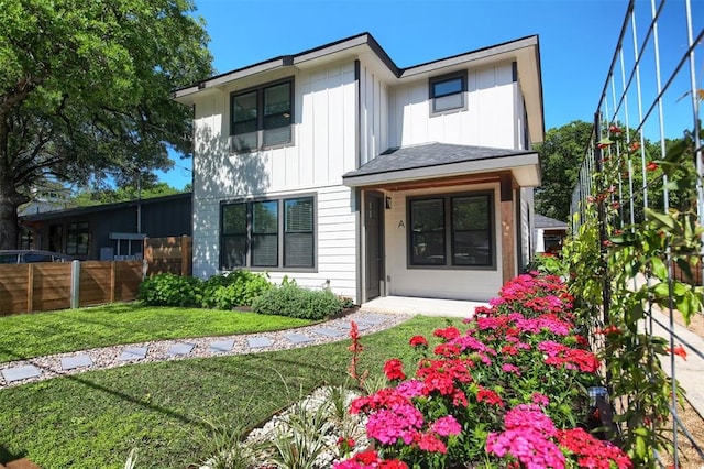 rear view of property with a yard