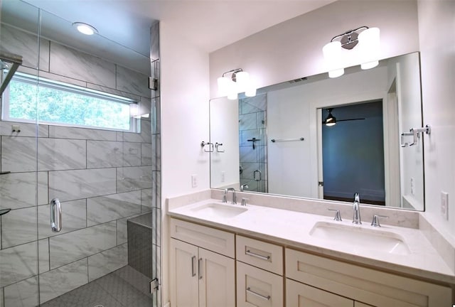 bathroom with ceiling fan, vanity, and a shower with door