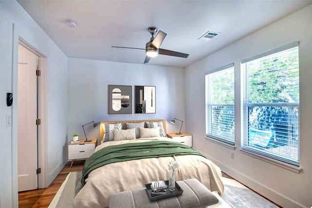 bedroom with ceiling fan and hardwood / wood-style floors