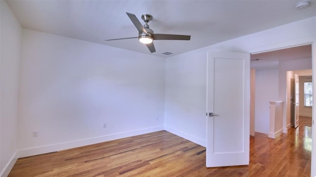 spare room with light hardwood / wood-style flooring and ceiling fan