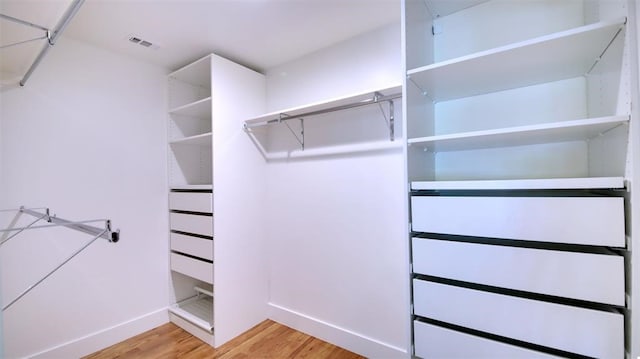 spacious closet featuring light hardwood / wood-style floors