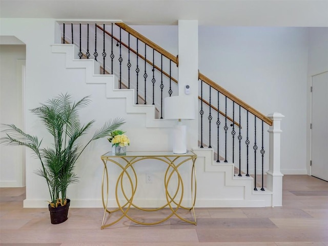 stairs featuring hardwood / wood-style flooring