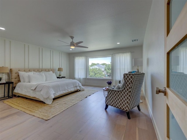 bedroom featuring ceiling fan and light hardwood / wood-style flooring