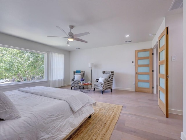 bedroom featuring light hardwood / wood-style floors and ceiling fan