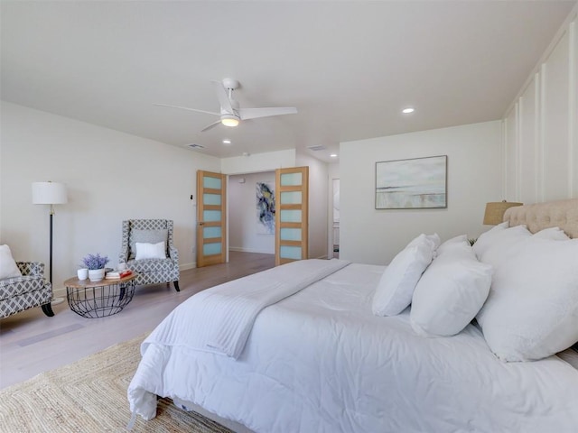 bedroom featuring hardwood / wood-style floors, ceiling fan, and a closet