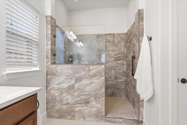 bathroom with vanity and tiled shower