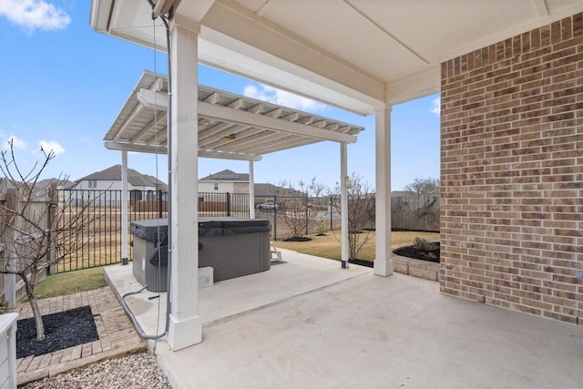 view of patio / terrace with a hot tub and a pergola