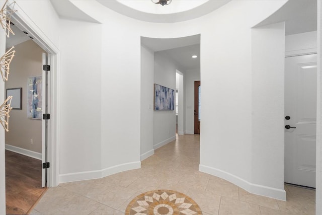 hallway featuring light tile patterned flooring