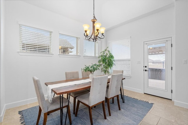 dining room with light tile patterned floors and a chandelier