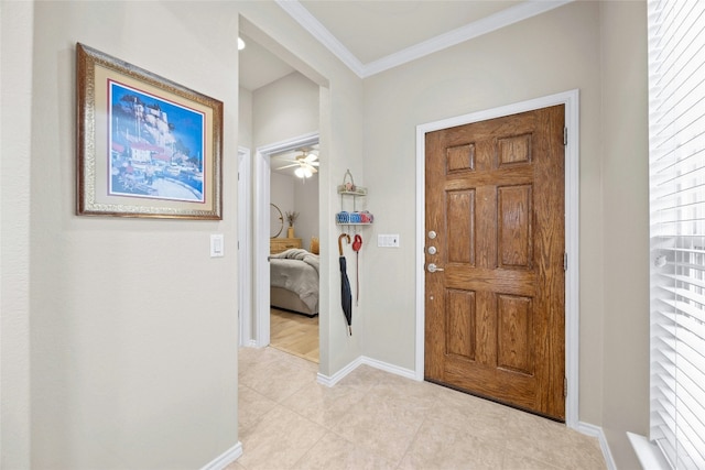 tiled entrance foyer featuring crown molding