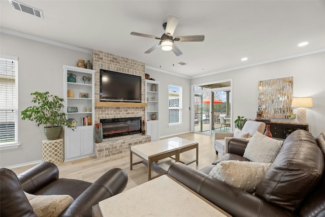 living room featuring ornamental molding, plenty of natural light, and a brick fireplace