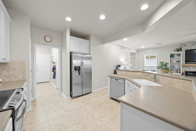 116 Granite Peak Cv, Georgetown, TX 78633 - kitchen with white cabinets, light tile patterned flooring, appliances with stainless steel finishes, a sink, and recessed lighting