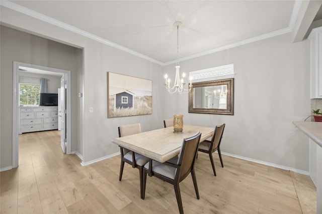 dining space featuring ornamental molding, a chandelier, and light hardwood / wood-style floors