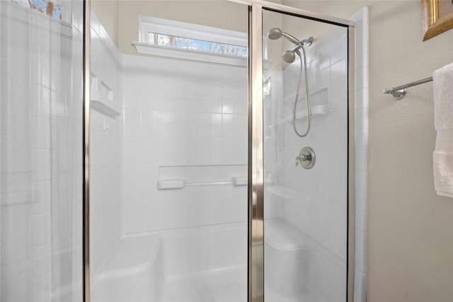 bathroom featuring a shower with shower door