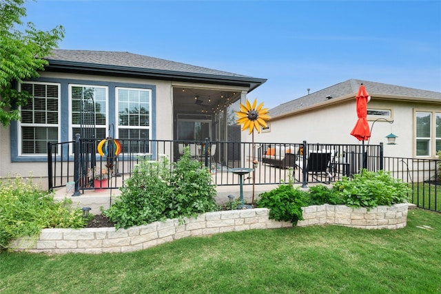 116 Granite Peak Cv, Georgetown, TX 78633 - rear view of house featuring roof with shingles, a lawn, a sunroom, fence, and stucco siding