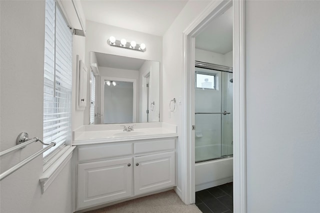 bathroom featuring bath / shower combo with glass door and vanity