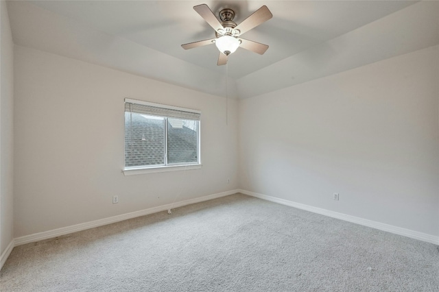 carpeted spare room featuring ceiling fan