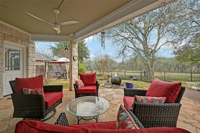 view of patio / terrace featuring a gazebo, outdoor lounge area, and ceiling fan