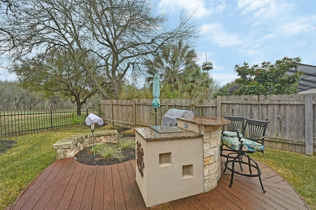 wooden deck with area for grilling and exterior bar