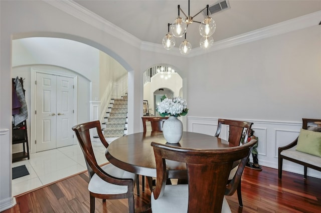 dining room featuring ornamental molding and hardwood / wood-style floors