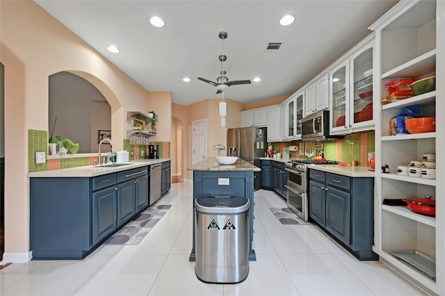 kitchen with blue cabinets, sink, white cabinets, and appliances with stainless steel finishes