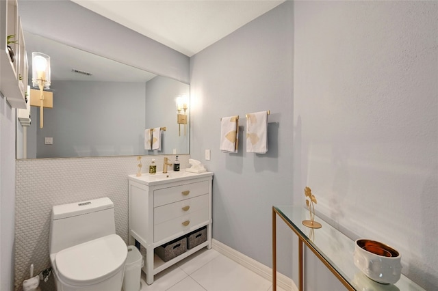 bathroom featuring tile patterned flooring, vanity, and toilet